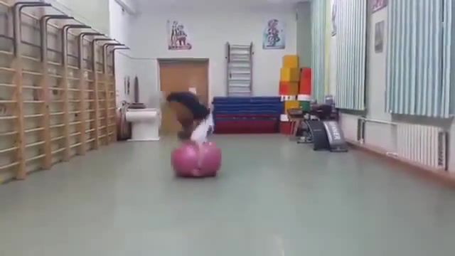 Girl does backflips with exercise ball