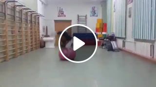 Girl does backflips with exercise ball