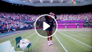Serena williams c walks after winning match while venus celebrates