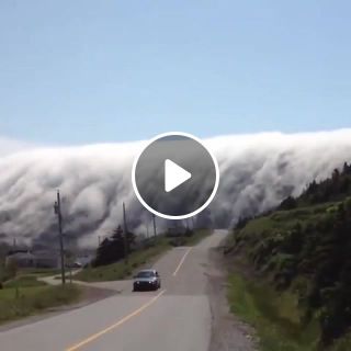 Cloud waterfall over long range mountains in lark harbour, newfoundland, canada