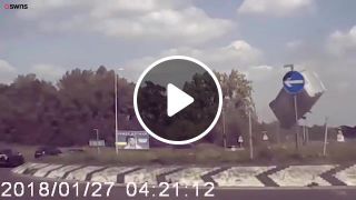 Van flies over roundabout