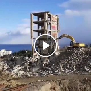 This is the end. Excavator waying building demolition fail