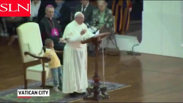 Pope and little boy, the pope, pope francis, boy on stage with pope, boy wanders on stage with pope. #2