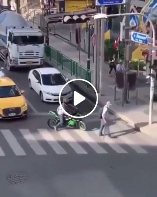 Biker blocks traffic to help someone crossing the street