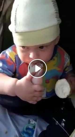Funny baby eating ice cream with foot