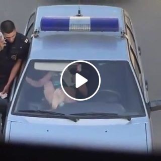 Police officer tries to restrain a wild russian woman